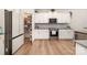 Modern kitchen featuring white cabinets, stainless steel appliances, and a convenient pantry at 9031 Odell Corners Nw Blvd, Concord, NC 28027