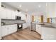 Well-lit kitchen with stainless steel appliances, white cabinetry, and an open layout at 9031 Odell Corners Nw Blvd, Concord, NC 28027