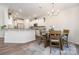 Bright kitchen with white cabinets, stainless steel appliances, and a cozy dining area at 9031 Odell Corners Nw Blvd, Concord, NC 28027