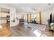 Open-concept living room with hardwood floors and an adjoining dining area and kitchen at 9031 Odell Corners Nw Blvd, Concord, NC 28027