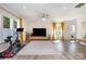 Spacious living room with large windows, hardwood floors, and stylish decor at 9031 Odell Corners Nw Blvd, Concord, NC 28027