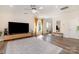 Bright living area featuring a ceiling fan, large windows, and hardwood floors at 9031 Odell Corners Nw Blvd, Concord, NC 28027