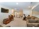 Spacious basement area featuring comfortable seating and stairs leading up to the next floor at 10421 Dominion Village Dr, Charlotte, NC 28269
