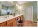 Bathroom featuring double sinks, vanity, mirror and tile floors at 10421 Dominion Village Dr, Charlotte, NC 28269