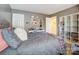 Bedroom with gray walls, a bedspread and a desk with storage shelves at 10421 Dominion Village Dr, Charlotte, NC 28269
