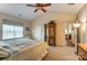 Bright bedroom featuring a ceiling fan, closet, and access to other rooms at 10421 Dominion Village Dr, Charlotte, NC 28269
