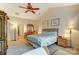 Bright bedroom featuring a ceiling fan, closet, and en suite bathroom at 10421 Dominion Village Dr, Charlotte, NC 28269
