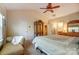 Spacious bedroom with a ceiling fan, closet, and an open en suite bathroom at 10421 Dominion Village Dr, Charlotte, NC 28269
