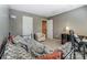 Bedroom featuring a daybed with gray walls and multiple doors to the hallway at 10421 Dominion Village Dr, Charlotte, NC 28269