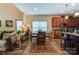 A cozy dining area offers wood floors and furniture, an area rug, and a view to the kitchen at 10421 Dominion Village Dr, Charlotte, NC 28269