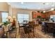 A well-lit dining area features wood floors, furniture, an area rug, and a view of the kitchen at 10421 Dominion Village Dr, Charlotte, NC 28269
