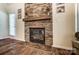 Close up of a charming fireplace made of stone that adds character to the house at 10421 Dominion Village Dr, Charlotte, NC 28269
