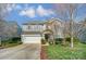 Two-story home featuring a well-maintained lawn and attached two car garage at 10421 Dominion Village Dr, Charlotte, NC 28269