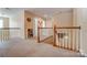 Open hallway area featuring neutral walls, a carpeted floor and staircase with a wooden railing at 10421 Dominion Village Dr, Charlotte, NC 28269