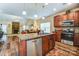 Bright kitchen with island, stainless appliances and finishes, that flows into a combined dining and living space at 10421 Dominion Village Dr, Charlotte, NC 28269