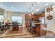 An open kitchen flows into the dining area with modern cabinetry, island seating, and stylish countertops at 10421 Dominion Village Dr, Charlotte, NC 28269