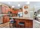 An open kitchen features stainless appliances, a granite island with seating, and updated cabinetry at 10421 Dominion Village Dr, Charlotte, NC 28269