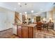 Bright kitchen with an island, stainless appliances, and granite countertops, flowing into the dining and living areas at 10421 Dominion Village Dr, Charlotte, NC 28269