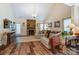 Spacious living room featuring a stone fireplace, hardwood floors, and large windows at 10421 Dominion Village Dr, Charlotte, NC 28269