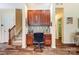 A built-in desk offers a functional office nook with shelving and drawers next to the staircase at 10421 Dominion Village Dr, Charlotte, NC 28269