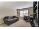 Office with sofa and large window for natural light, plus a dark desk and shelves at 10421 Dominion Village Dr, Charlotte, NC 28269