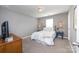 Bedroom featuring a comfortable bed, modern furniture, and a warm, inviting atmosphere with gray walls at 10694 Sapphire Trl, Davidson, NC 28036