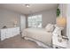 Bedroom with natural light, a neutral palette, a white dresser, and a window with views of the outside at 10694 Sapphire Trl, Davidson, NC 28036