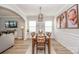 Well-lit dining room with wooden table set, chandelier, and decorative wall art, open to the living area at 10694 Sapphire Trl, Davidson, NC 28036
