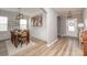 Elegant dining room with wainscoting, wood table set, modern lighting, and stylish wall decor at 10694 Sapphire Trl, Davidson, NC 28036