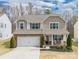 Charming two-story home with a well-manicured lawn, a two-car garage, and a welcoming front porch at 10694 Sapphire Trl, Davidson, NC 28036