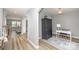 Inviting hallway with archways, stylish flooring, and a view into the living room and an office space at 10694 Sapphire Trl, Davidson, NC 28036