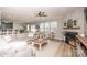 Spacious living room featuring a comfortable sofa, stylish coffee table, and a cozy fireplace with brick surround at 10694 Sapphire Trl, Davidson, NC 28036