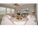 Cozy living room featuring a stone fireplace, ceiling fan, and a comfortable sectional sofa at 10694 Sapphire Trl, Davidson, NC 28036