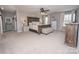 Spacious main bedroom with a ceiling fan, a large bed, matching nightstands, and windows with elegant drapery at 10694 Sapphire Trl, Davidson, NC 28036