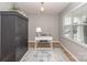 Bright and airy office space featuring a modern desk, chair, and storage, complemented by a decorative rug at 10694 Sapphire Trl, Davidson, NC 28036