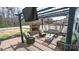 Inviting brick patio featuring a cozy fireplace, outdoor seating, and string lights for relaxing evenings at 10694 Sapphire Trl, Davidson, NC 28036