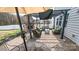 Relaxing brick patio with a cozy fireplace, comfortable seating, and shade umbrella at 10694 Sapphire Trl, Davidson, NC 28036