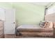 Cozy bedroom featuring neutral walls, a plush bed, and ample natural light at 107 Forester St, Mooresville, NC 28117