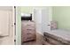 Well-lit bedroom with neutral walls, a dresser, and easy access to an ensuite bathroom at 107 Forester St, Mooresville, NC 28117