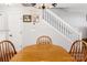 Warm dining area showcasing a wooden table and chairs, adjacent to a staircase, ideal for Gathering meals at 107 Forester St, Mooresville, NC 28117