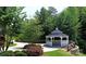 A cozy gazebo nestled in a lush landscape with mature trees and a paved path at 107 Forester St, Mooresville, NC 28117