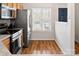 Modern kitchen with stainless steel appliances, wood cabinets, and ample natural light for a bright atmosphere at 107 Forester St, Mooresville, NC 28117