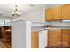 Functional kitchen area with wood cabinets, a dishwasher, and seamless access to the adjacent dining space at 107 Forester St, Mooresville, NC 28117