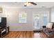 Inviting living room featuring hardwood floors, a ceiling fan, and a glass-paneled door to the backyard at 107 Forester St, Mooresville, NC 28117