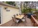 Back deck with dining table and grill, ideal for outdoor entertaining and enjoying the surrounding nature at 113 Hidden Ln, Mooresville, NC 28117