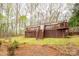 Lush backyard showcasing an inviting deck and patio, ideal for outdoor living and enjoying the natural surroundings at 113 Hidden Ln, Mooresville, NC 28117