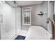 Bathroom with walk-in shower and free-standing soaking tub, designed for relaxation and tranquility at 113 Hidden Ln, Mooresville, NC 28117