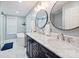 Bathroom featuring dual sinks, marble countertops, modern fixtures, and a separate tub and shower at 113 Hidden Ln, Mooresville, NC 28117