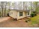 Exterior shot of a cozy home with gravel driveway and a small, manicured garden at 113 Hidden Ln, Mooresville, NC 28117