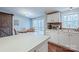 Open-concept kitchen with white cabinets, island counter, and access to a deck via sliding glass doors at 113 Hidden Ln, Mooresville, NC 28117